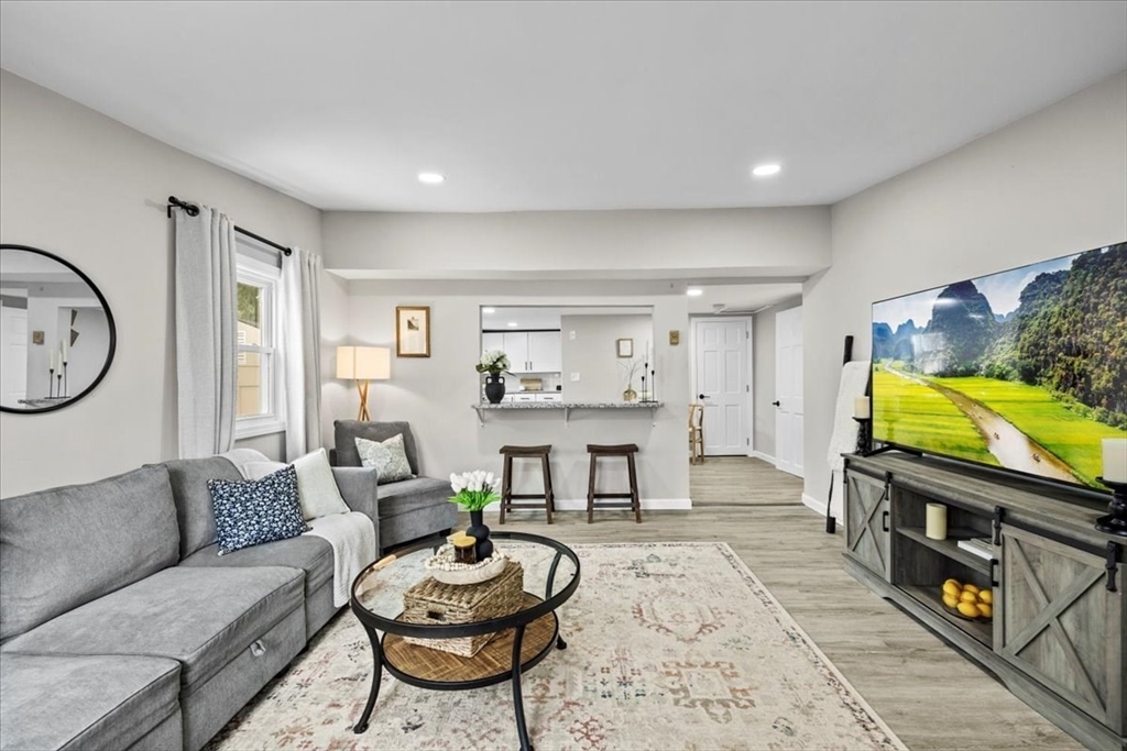14 Pinehurst Drive Wareham, MA 02571 - Photo 6 of 41 a living room with furniture a flat screen tv and a fireplace