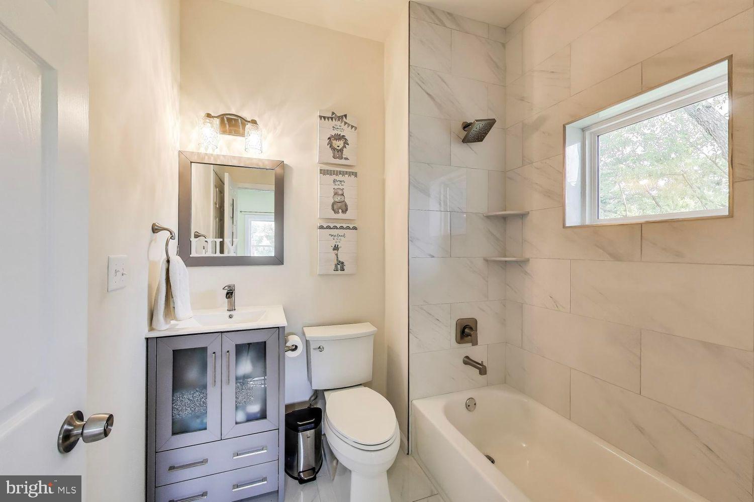 5408 Danville Street Springfield, VA 22151 - Photo 14 of 29 a bathroom with a bathtub shower sink mirror and toilet