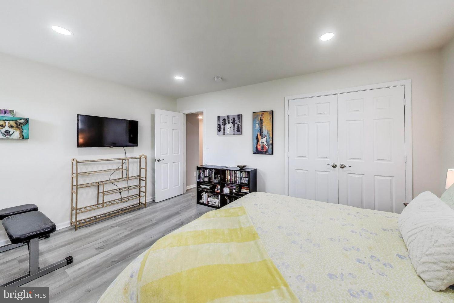 5408 Danville Street Springfield, VA 22151 - Photo 18 of 29 a spacious bedroom with a bed and a flat screen tv