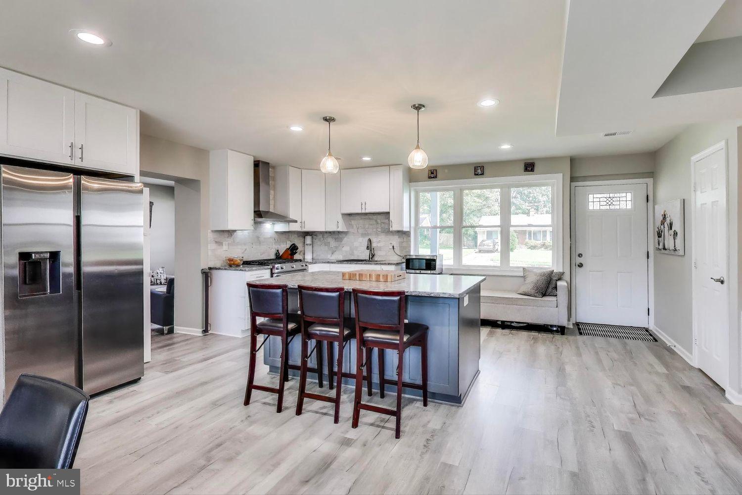 5408 Danville Street Springfield, VA 22151 - Photo 4 of 29 a kitchen with refrigerator a sink and chairs
