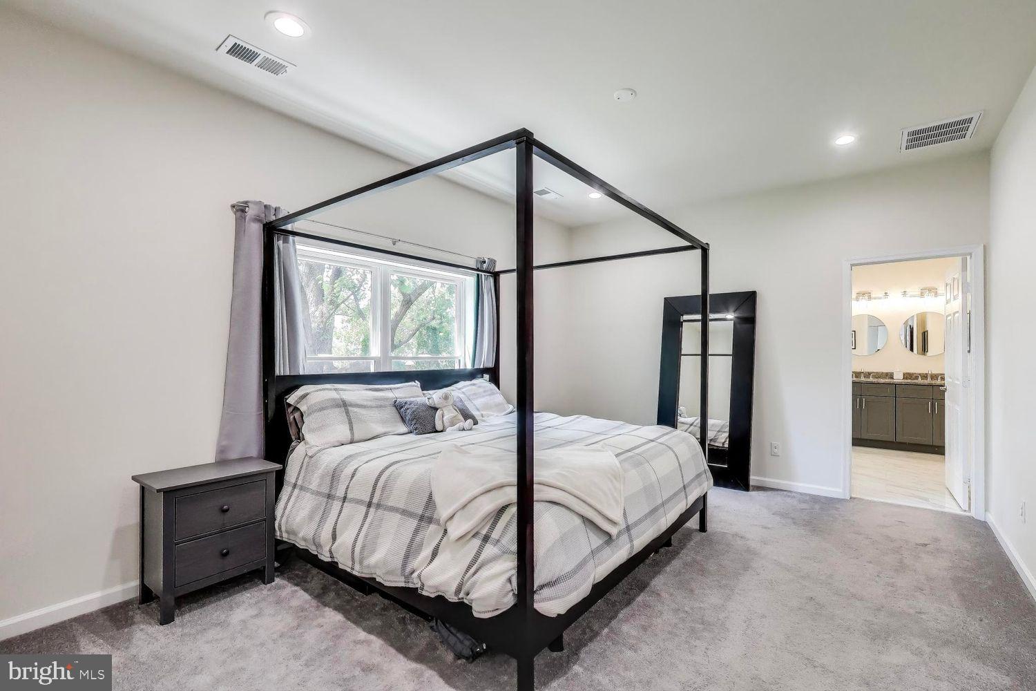 5408 Danville Street Springfield, VA 22151 - Photo 6 of 29 a bedroom with a large bed and a chandelier