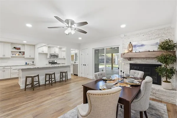 a living room with furniture a fireplace and kitchen view