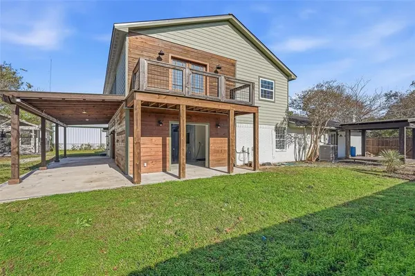 a view of a house with a yard and pathway