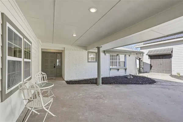 a living room with a large window and chairs