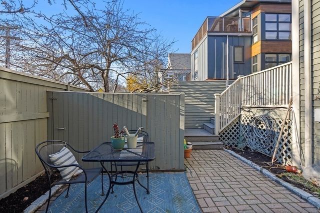 a view of a chairs and table in the balcony
