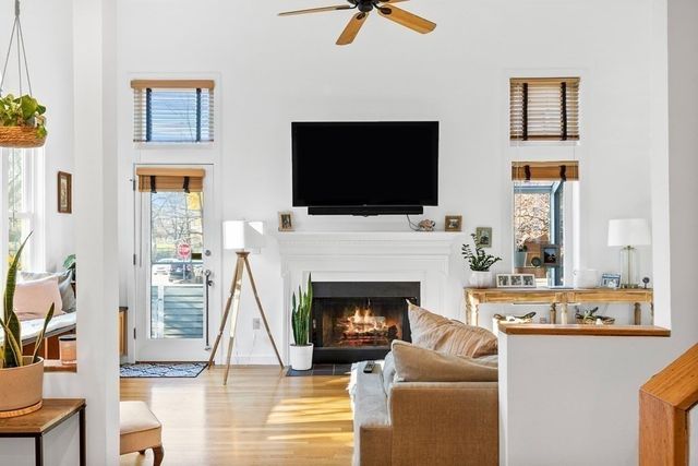 a living room with furniture a flat screen tv and a fireplace