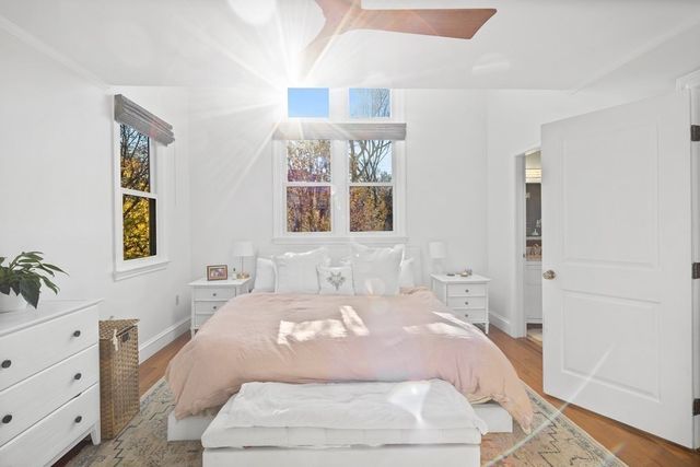 a bedroom with a large bed and a chandelier