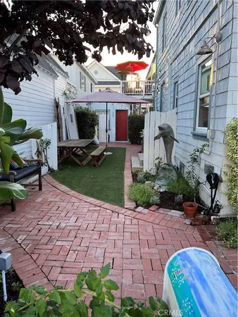 a view of a patio with table and chairs potted plants