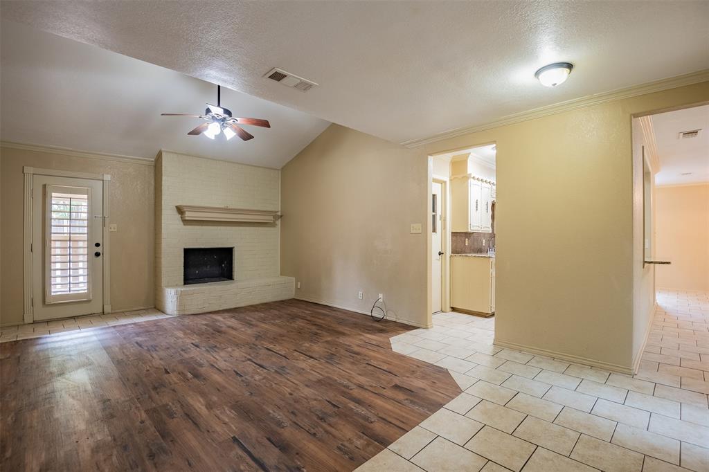 805 North Fielder Road Arlington, TX 76012 - Photo 3 of 17 a view of an empty room with a fireplace
