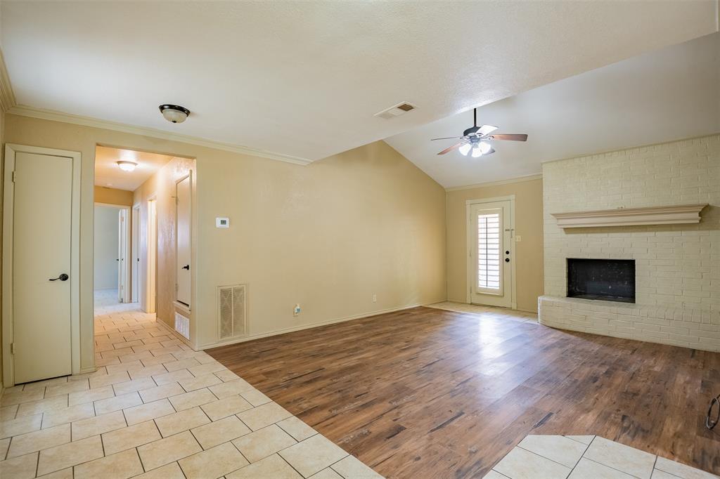 805 North Fielder Road Arlington, TX 76012 - Photo 4 of 17 a view of a room with a fireplace closet and wooden floor