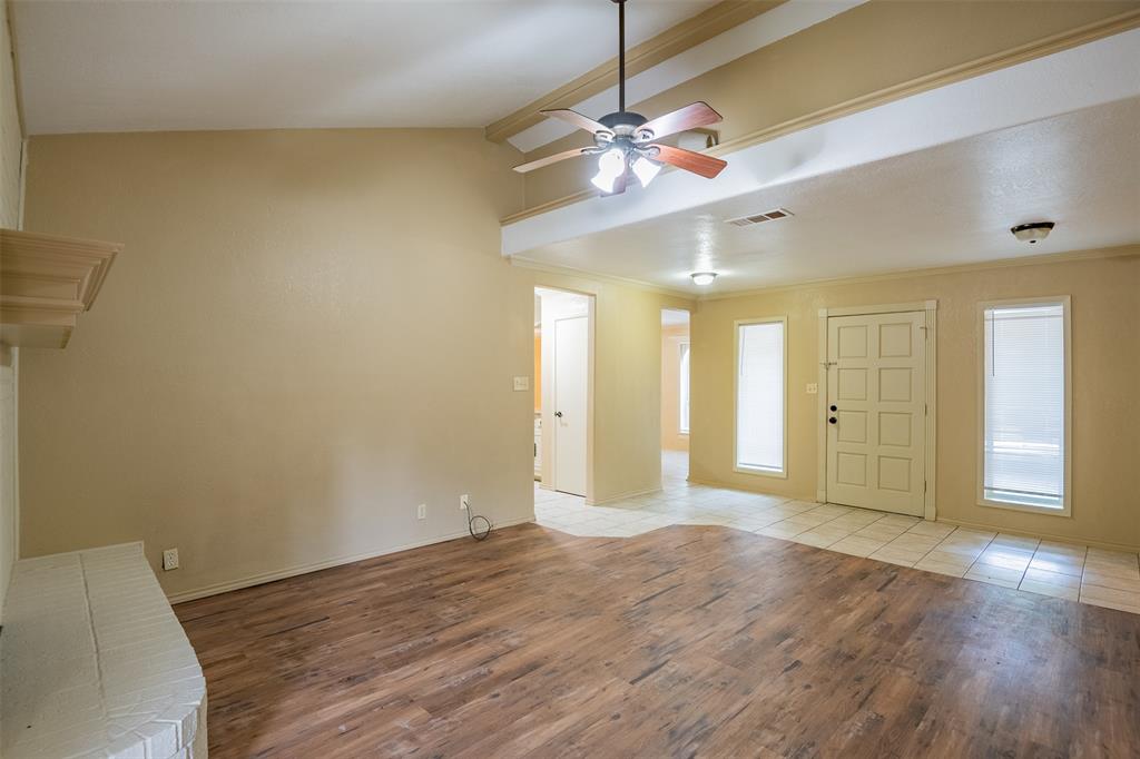 805 North Fielder Road Arlington, TX 76012 - Photo 5 of 17 a view of an empty room with wooden floor and a window