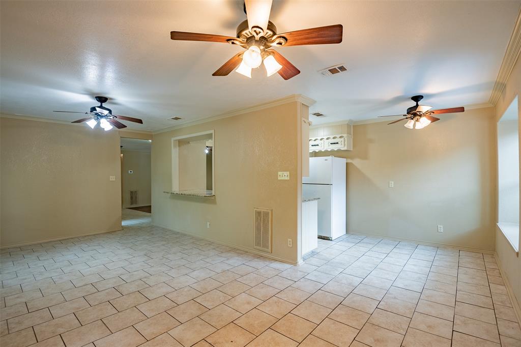 805 North Fielder Road Arlington, TX 76012 - Photo 6 of 17 a view of an empty room and chandelier fan