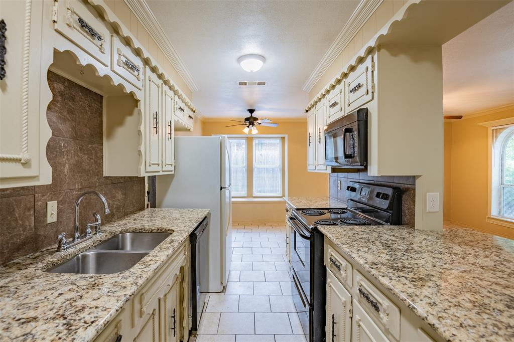 805 North Fielder Road Arlington, TX 76012 - Photo 8 of 17 a kitchen with stainless steel appliances granite countertop a sink stove and refrigerator