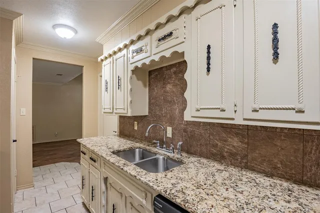a kitchen with granite countertop a sink and a stove