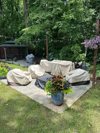 a view of a patio with table and chairs potted plants