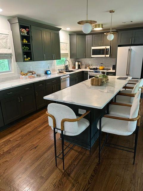 2434 Rockcliff Road Southeast Atlanta, GA 30316 - Photo 3 of 13 a kitchen with kitchen island a dining table and chairs