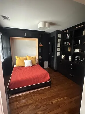 a bedroom with a bed and a tv on table