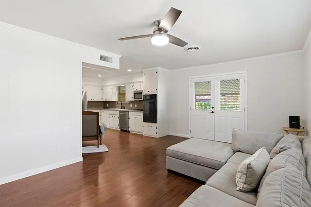 a living room with furniture and kitchen view
