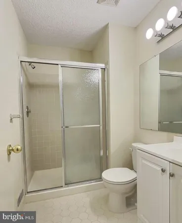 a bathroom with a shower a toilet and a sink