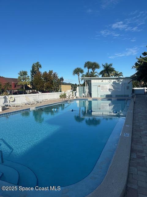 223 Columbia Drive, Unit 114 Cape Canaveral, FL 32920 - Photo 11 of 14 a view of a lake with houses in the background