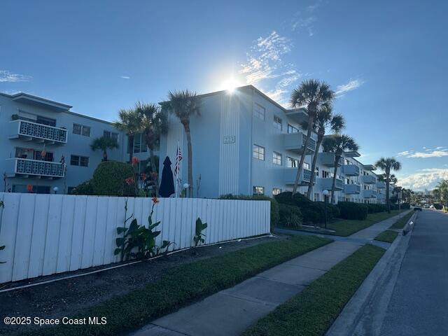 223 Columbia Drive, Unit 114 Cape Canaveral, FL 32920 - Photo 14 of 14 a front view of a house with garden