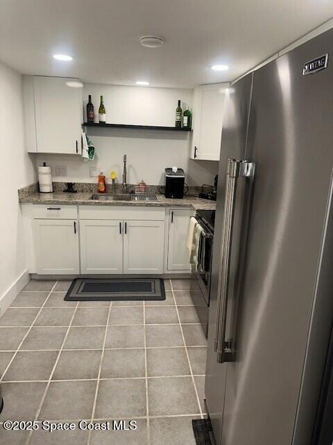 223 Columbia Drive, Unit 114 Cape Canaveral, FL 32920 - Photo 5 of 14 a kitchen with stainless steel appliances granite countertop a refrigerator and a sink