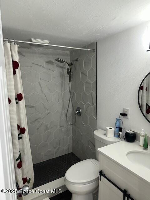 223 Columbia Drive, Unit 114 Cape Canaveral, FL 32920 - Photo 7 of 14 a bathroom with a sink a toilet and shower