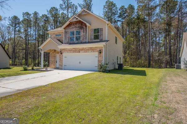 a front view of a house with a yard