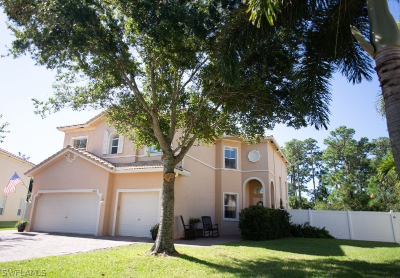 5517 Spanish River Road Fort Pierce, FL 34951 - Photo 1 of 24 a front view of a house with a yard and garage