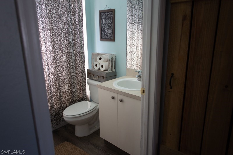 5517 Spanish River Road Fort Pierce, FL 34951 - Photo 11 of 24 a white toilet sitting next to a bathroom sink