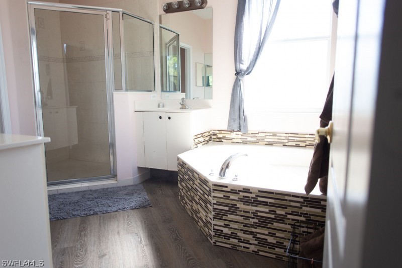 5517 Spanish River Road Fort Pierce, FL 34951 - Photo 14 of 24 a bathroom with a bathtub and a sink