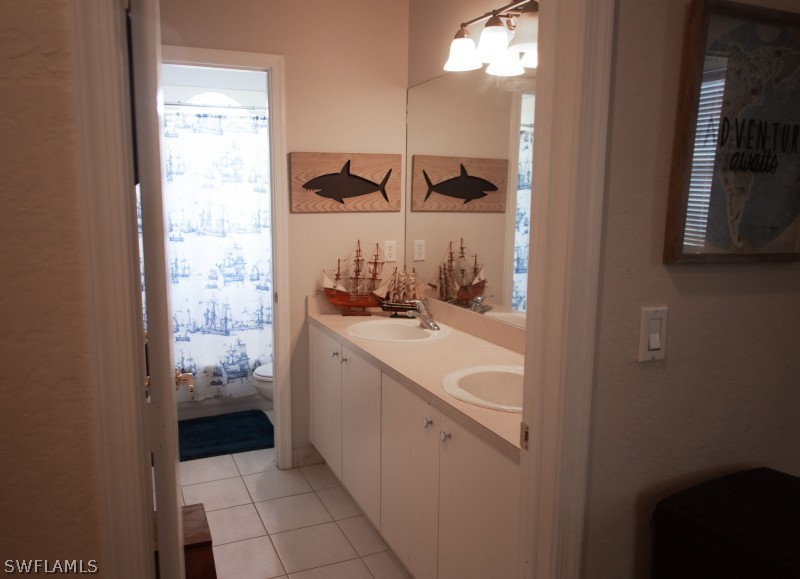 5517 Spanish River Road Fort Pierce, FL 34951 - Photo 20 of 24 a bathroom with a sink and a mirror