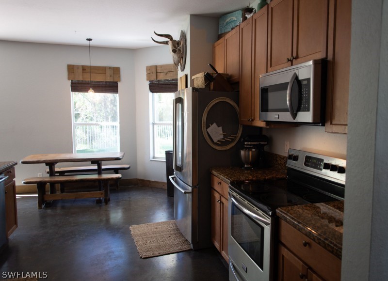 5517 Spanish River Road Fort Pierce, FL 34951 - Photo 7 of 24 a kitchen with granite countertop a stove a sink and a refrigerator