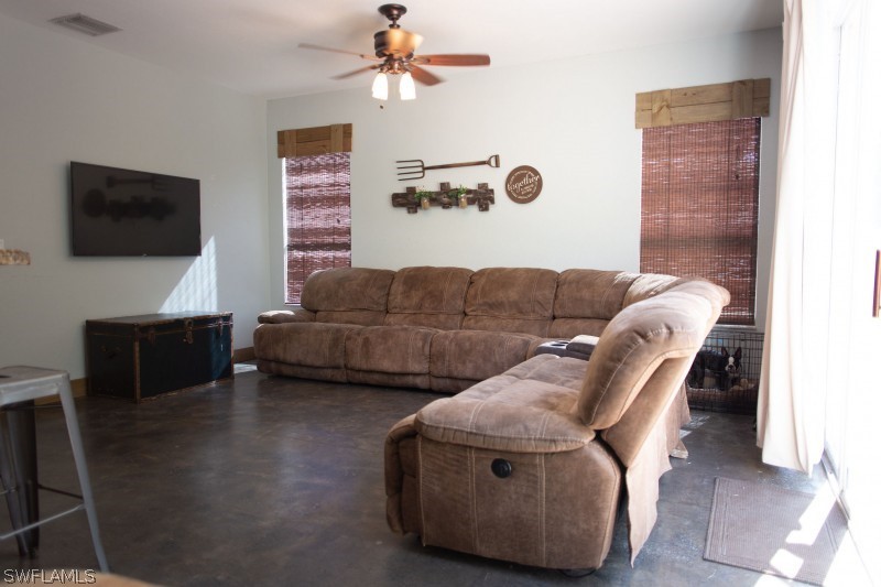 5517 Spanish River Road Fort Pierce, FL 34951 - Photo 10 of 24 a living room with furniture and a flat screen tv