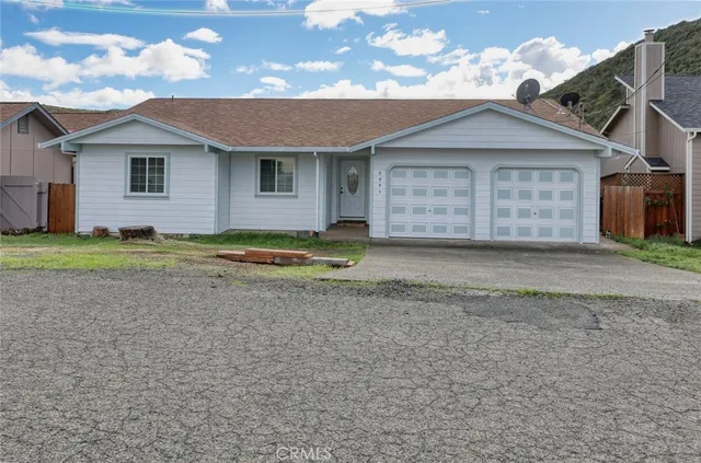 a view of a house with a yard and garage