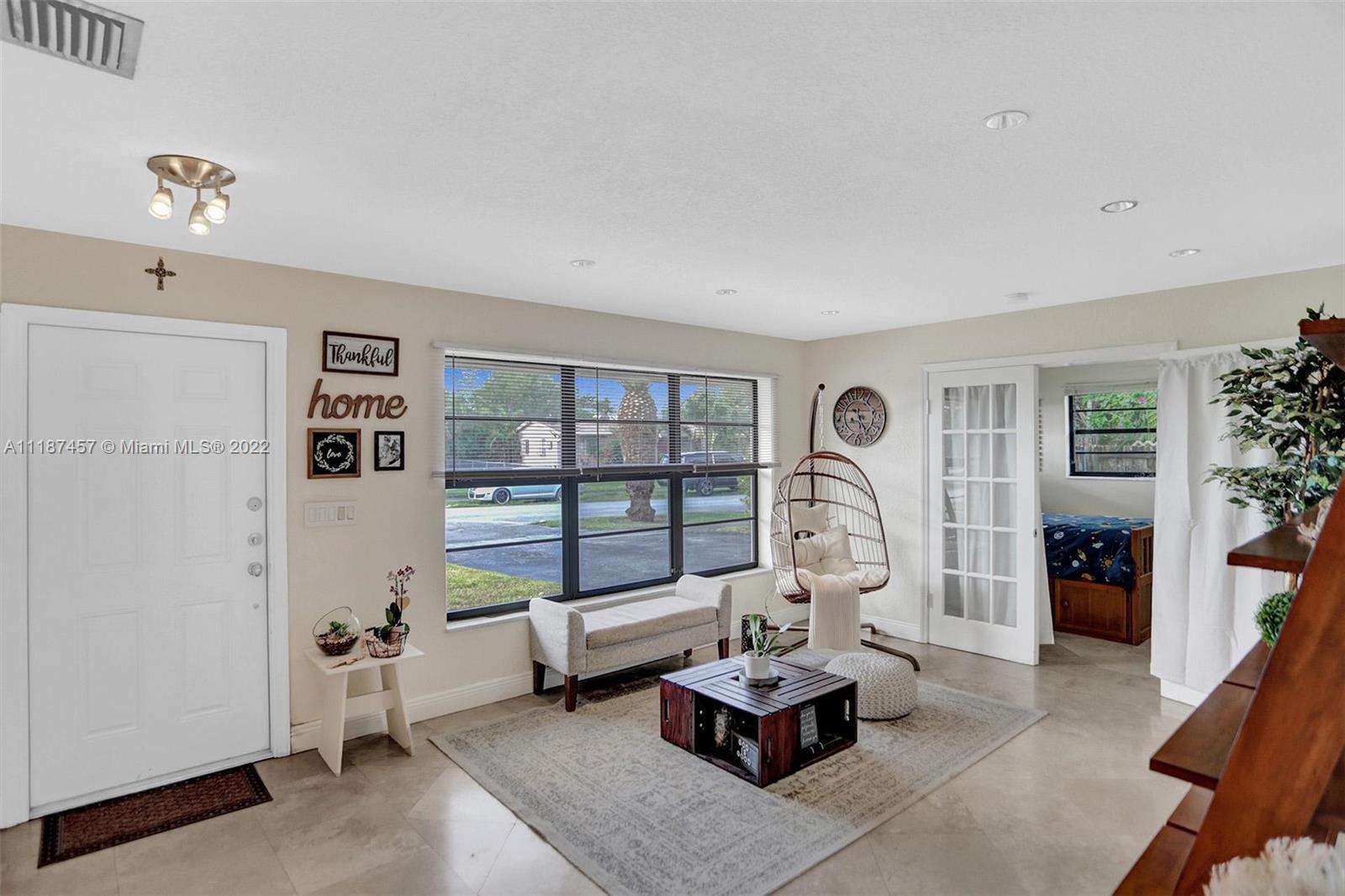 10401 Southwest 53rd Street Miami, FL 33165 - Photo 11 of 53 a living room with furniture a rug and white walls