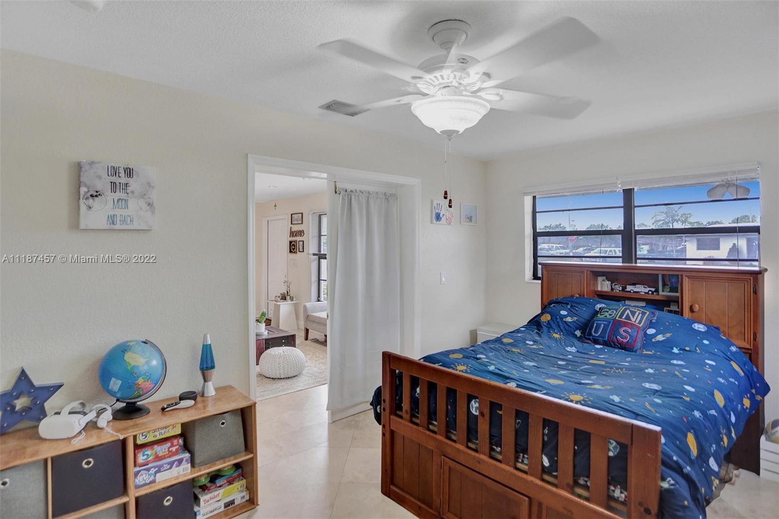 10401 Southwest 53rd Street Miami, FL 33165 - Photo 15 of 53 a bedroom with a bed and chandelier