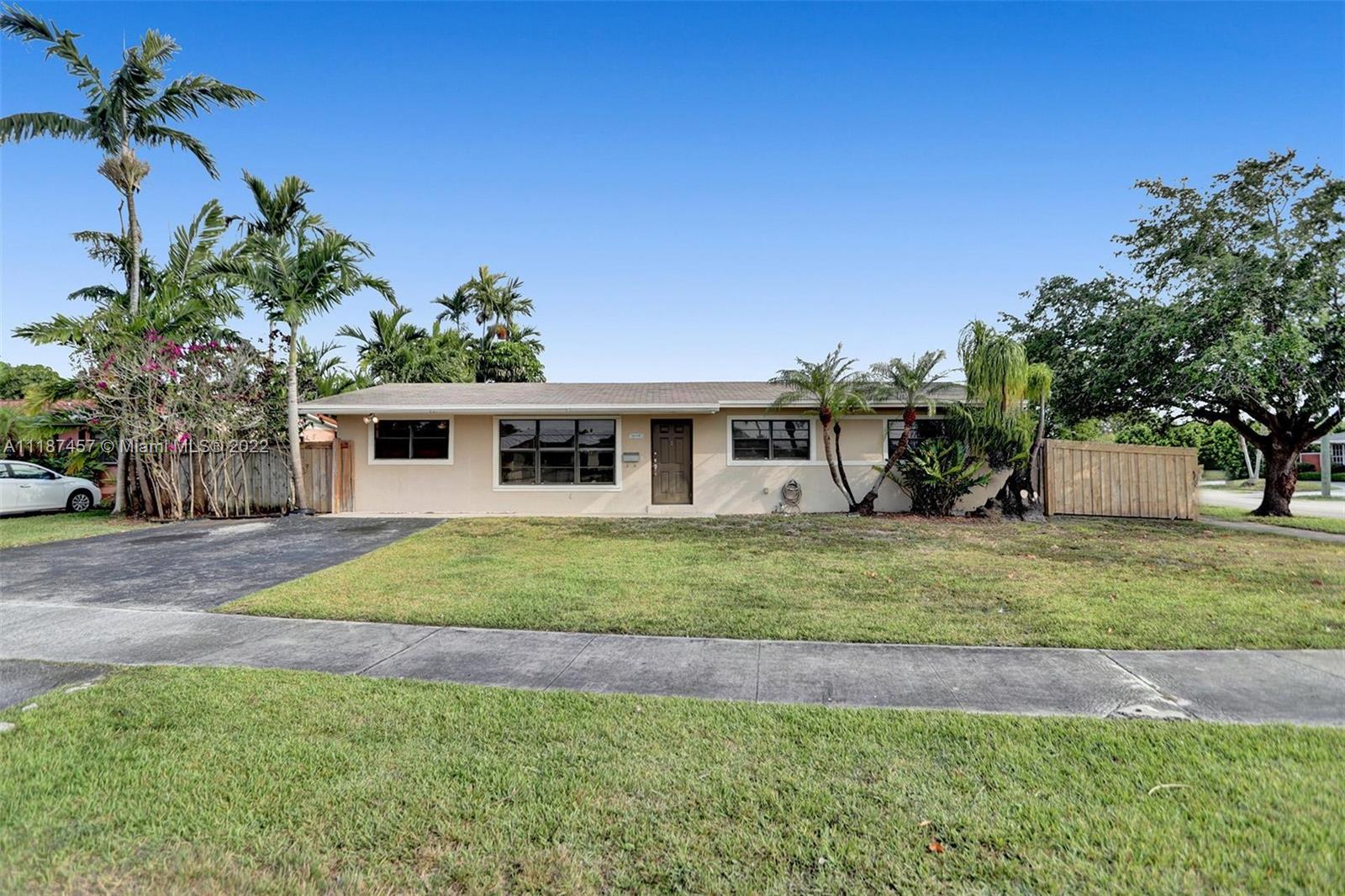10401 Southwest 53rd Street Miami, FL 33165 - Photo 17 of 53 a front view of a house with a garden