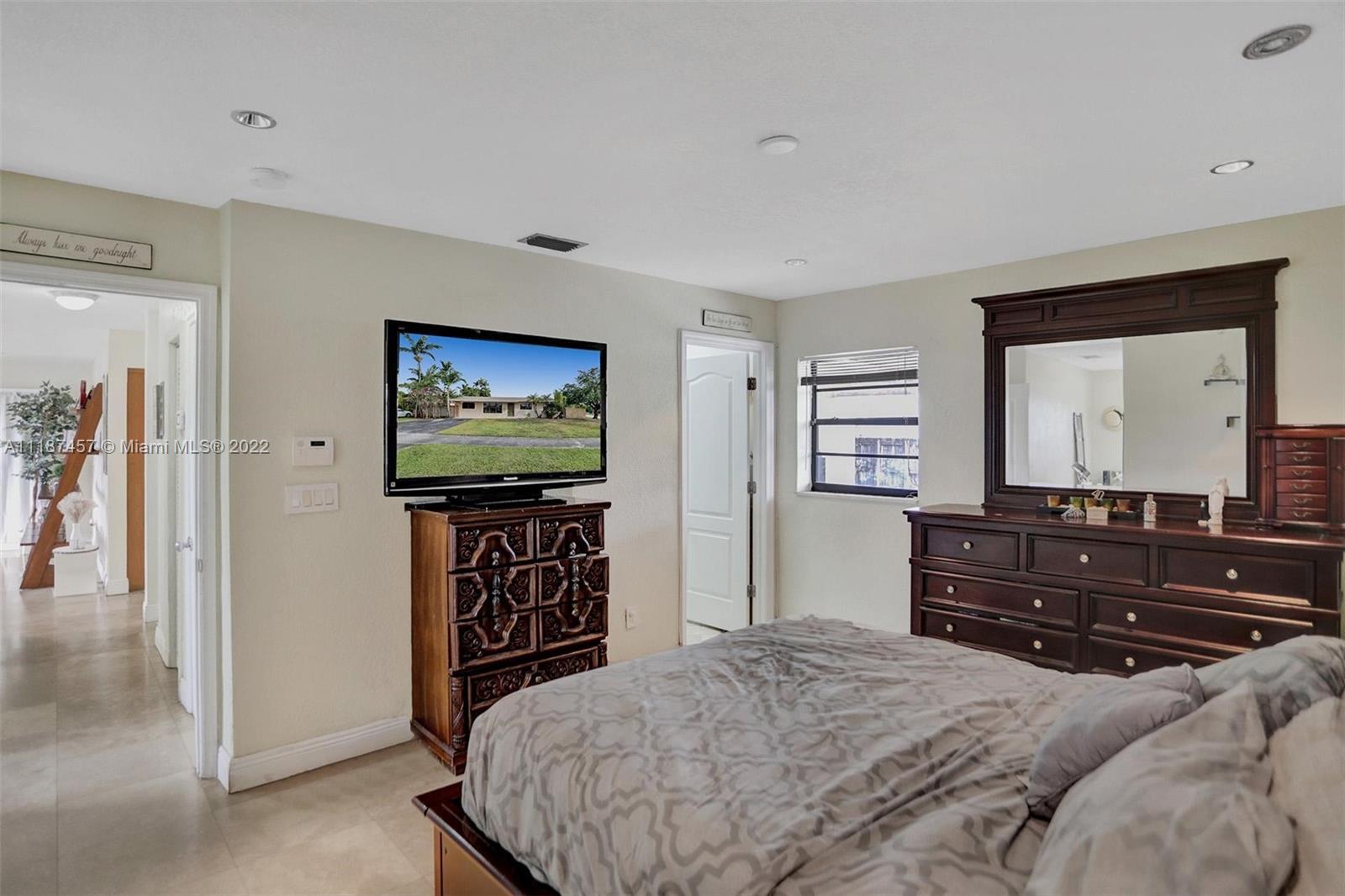 10401 Southwest 53rd Street Miami, FL 33165 - Photo 23 of 53 a bedroom with a bed and a mirror