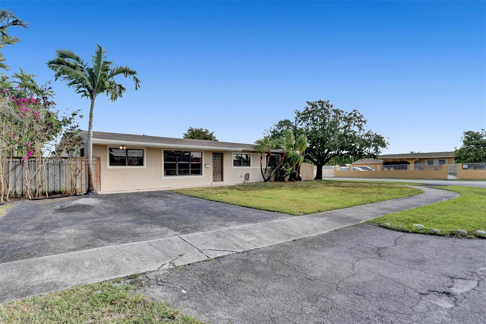 10401 Southwest 53rd Street Miami, FL 33165 - Photo 27 of 53 a front view of a house with a yard and garage