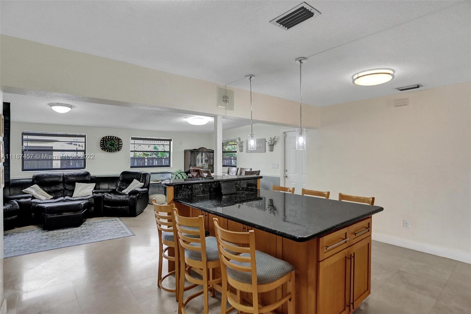 10401 Southwest 53rd Street Miami, FL 33165 - Photo 28 of 53 a kitchen with a counter space a sink and living room