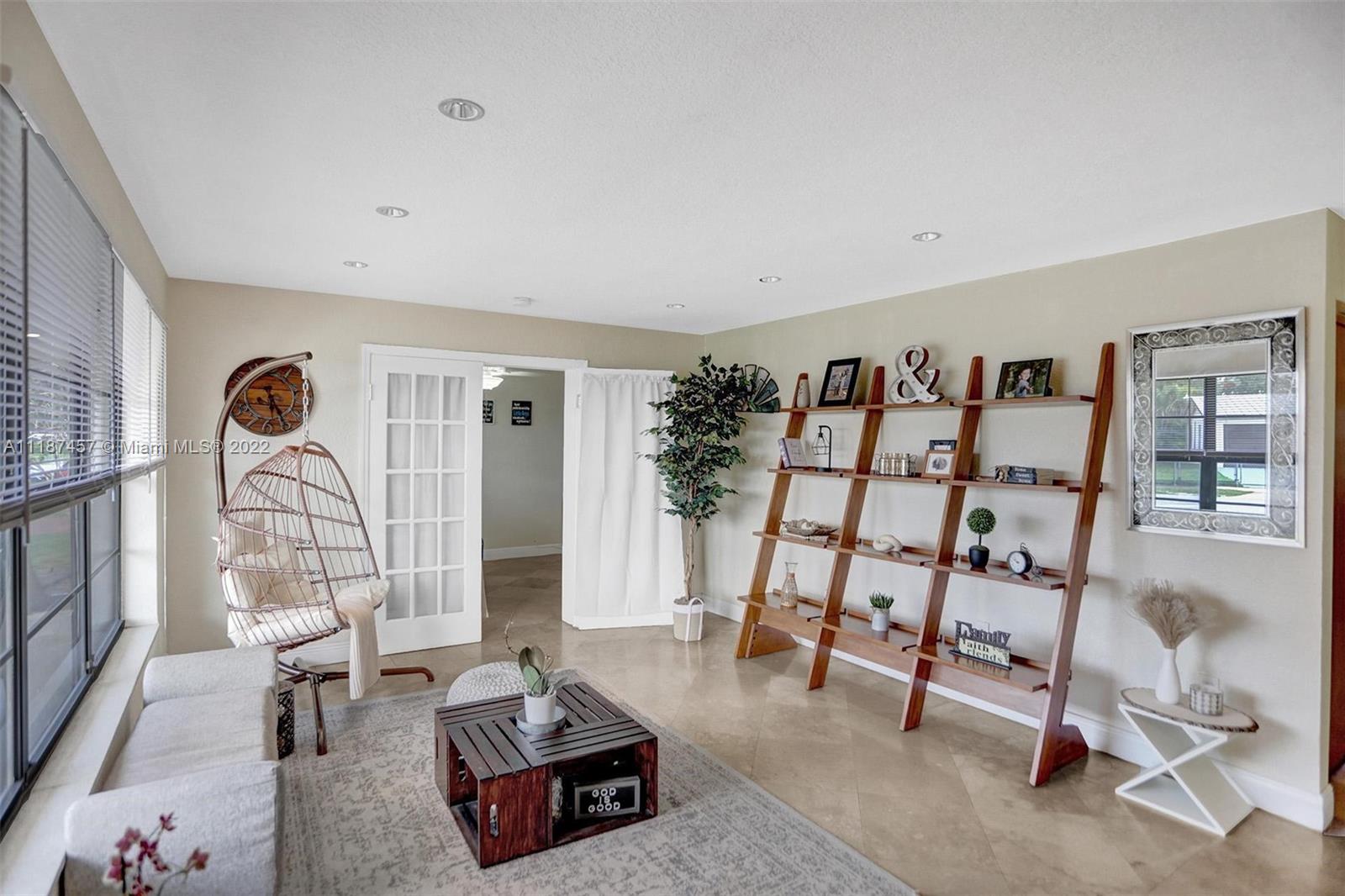 10401 Southwest 53rd Street Miami, FL 33165 - Photo 3 of 53 a living room with furniture a rug and white walls