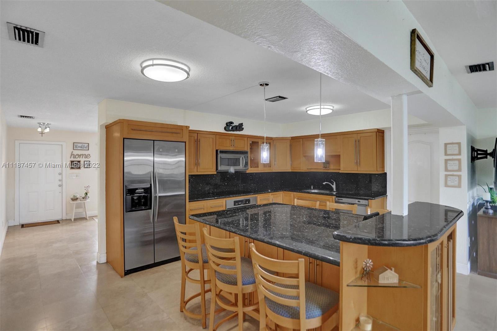 10401 Southwest 53rd Street Miami, FL 33165 - Photo 31 of 53 a kitchen with stainless steel appliances granite countertop a sink and a refrigerator