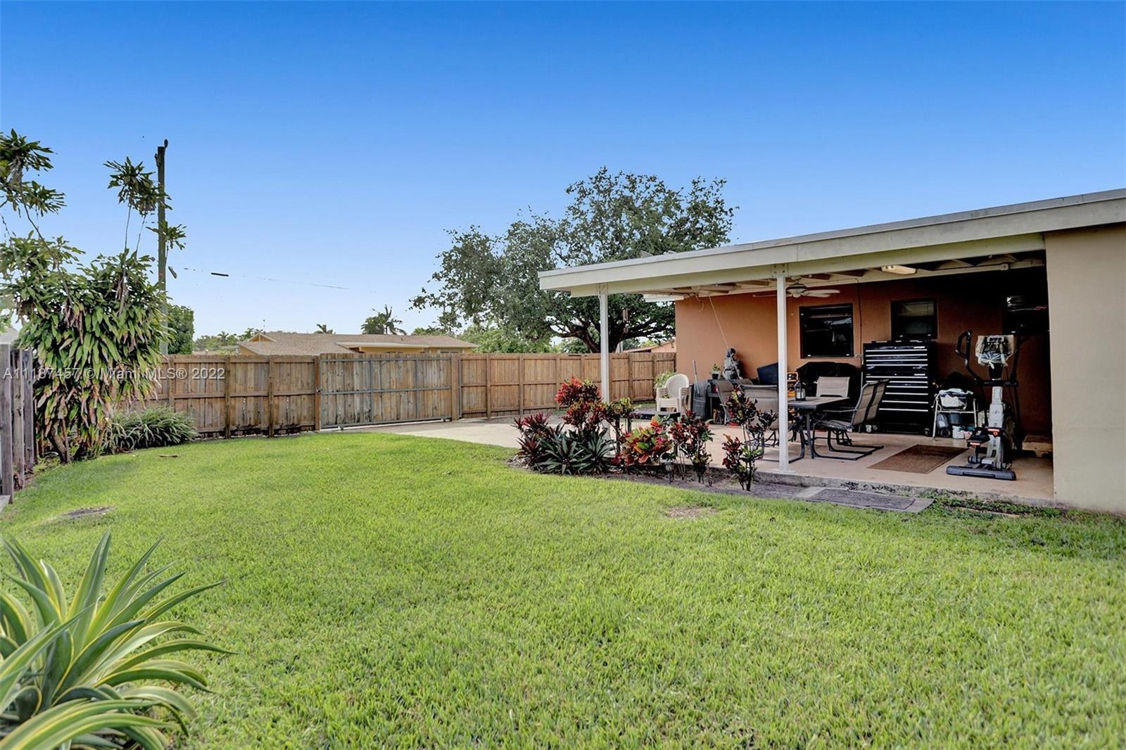 10401 Southwest 53rd Street Miami, FL 33165 - Photo 33 of 53 a view of a backyard with table and chairs and potted plants