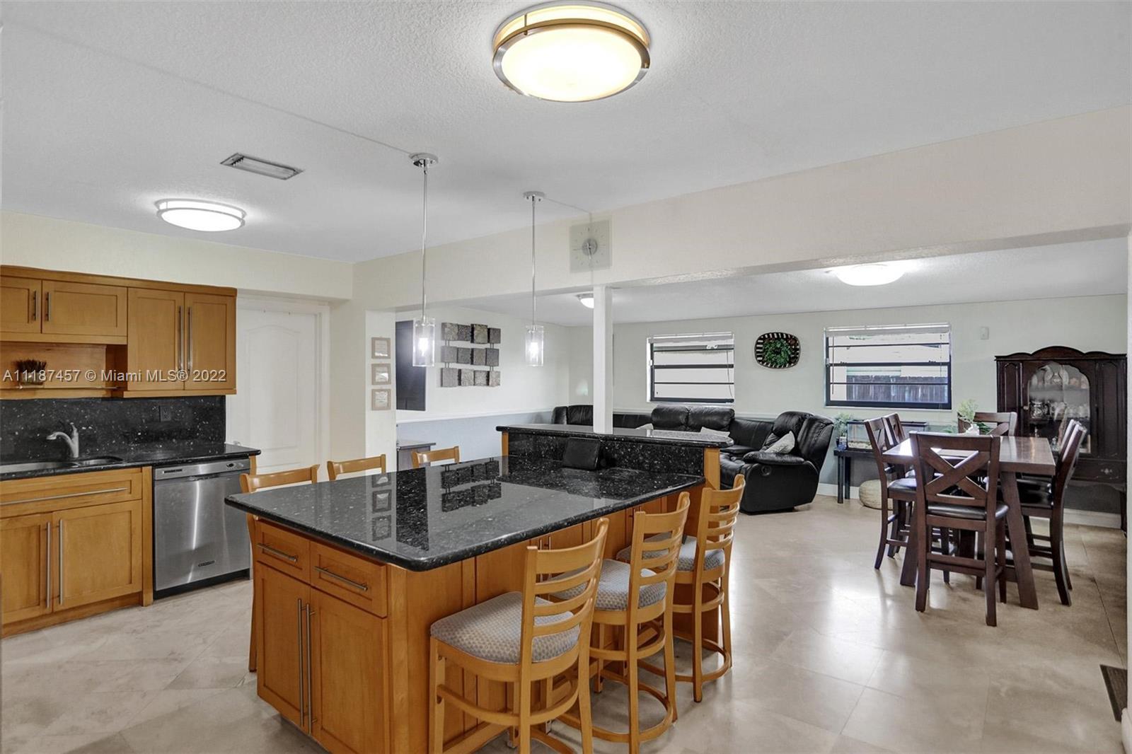 10401 Southwest 53rd Street Miami, FL 33165 - Photo 4 of 53 a kitchen with lots of counter top space and dining table