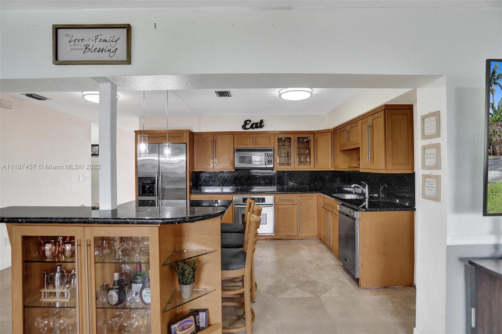 10401 Southwest 53rd Street Miami, FL 33165 - Photo 41 of 53 a kitchen with stainless steel appliances granite countertop a stove and a refrigerator