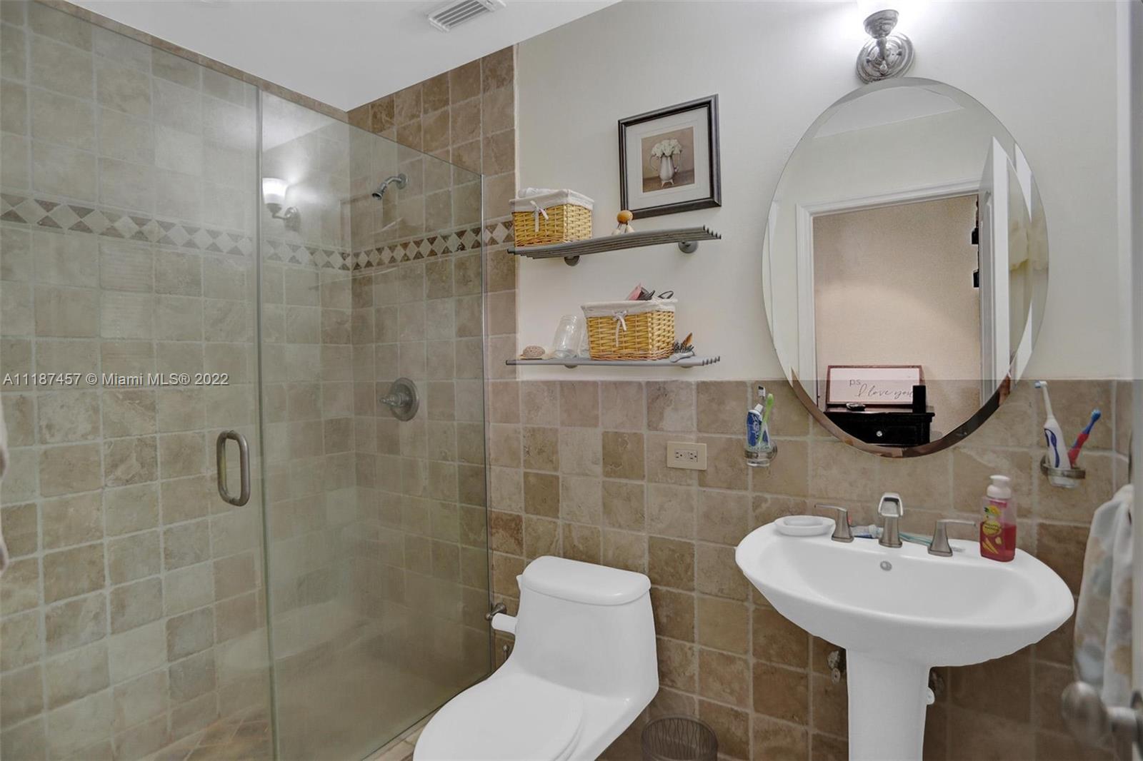 10401 Southwest 53rd Street Miami, FL 33165 - Photo 6 of 53 a bathroom with a sink mirror toilet and shower