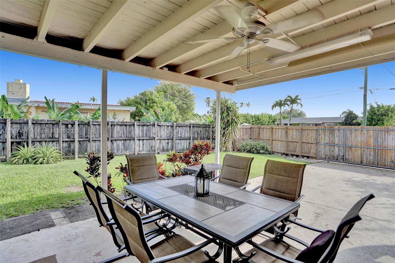 10401 Southwest 53rd Street Miami, FL 33165 - Photo 8 of 53 a view of a patio with a table chairs and a backyard