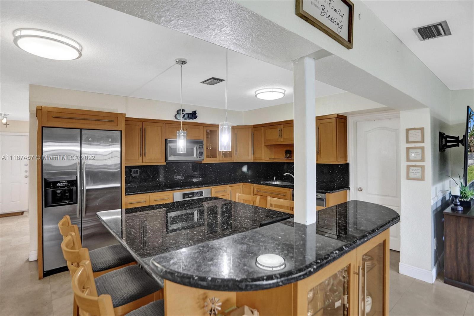 10401 Southwest 53rd Street Miami, FL 33165 - Photo 10 of 53 a kitchen with stainless steel appliances granite countertop a sink a refrigerator and a granite counter tops