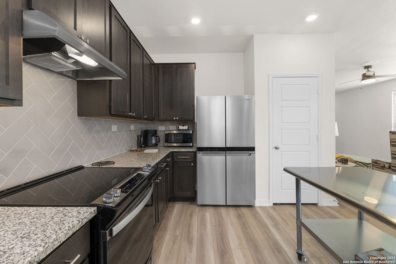 14839 Vance Jackson Road, Unit 1101 San Antonio, TX 78249 - Photo 12 of 31 a kitchen with a refrigerator sink and stove